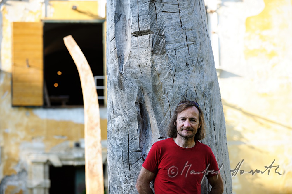 Johann Feilacher mit Baum-Skulptur vor dem Atelier