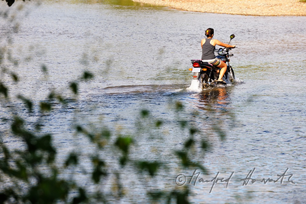 Motorrad quert einen Flusslauf