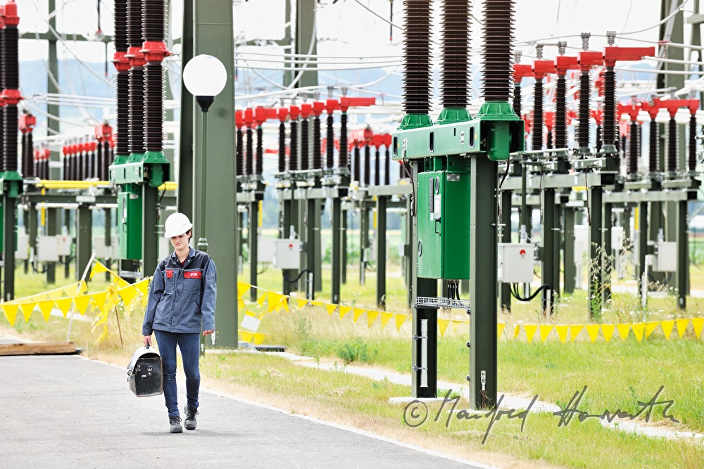 Elektromonteurin mit Werkzeugkoffer auf dem Weg zur Arbeit
